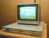 Nova 620S Time Base Corrector front panel view with Panasonic CRT monitor on top displaying video footage of a biplane