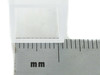 Close-up of Brandtech macro cuvette stopper cap next to metric ruler — cap aperture detail in millimeters