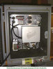 Beckman F3 Oxygen Analyzer – interior close-up showing terminal block with colored wiring, transformer, sealed metal module, and two circular sensor ports on upper panel