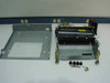 Disassembled Dataproducts Jolt showing steel base enclosure separated from the roller/heater mechanism assembly, with mounting hardware and rubber feet laid out