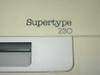 Supertype 230 model name badge close-up on front panel of Olympia electronic typewriter