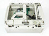 Lexmark 11K0575 Optra T paper tray – top-down interior view showing paper feed motor, lift plate, guide rails, wiring harness, and internal components