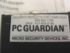 Close-up of PC Guardian label on lock body reading 'Security Products for Computers — Micro Security Devices, Inc.' with contact numbers