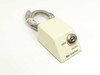 MAC Guardian 531 port lock unit — three-quarter view showing keyed lock cylinder and LOCK/UNLOCK labels on beige wedge housing