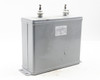 TOEI O82130 capacitor – three-quarter right rear view showing gray enclosure, two ceramic terminals, and base flanges