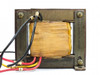 Burton 15180 transformer — rear view showing coil winding, lamination stack, mounting frame, and color-coded wire leads with ring terminals