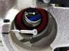 Nicolet Magna spectrometer end plate — close-up through-bore view showing internal optical mirror or beamsplitter element with blue coating and needle positioning mechanism