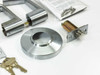 Schlage AL53PD SAT 626 components laid out: pair of Saturn lever handles, rose plate, latch assembly, keys, screws bag, and strike plate
