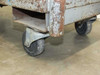 Close-up of swivel caster wheels on the base of the industrial utility delivery cart showing wear and construction detail