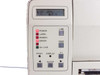 SATO M-8400 close-up of front control panel showing LCD display with garbled text, POWER/LABEL/RIBBON/ERROR/ON LINE LED indicators, and LINE, FEED, F1, PRINT, DISPLAY, ENTER buttons