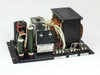 Kitafuji Origin 0038 open-frame AC-to-DC power supply – three-quarter front view showing transformer, capacitors, and terminal block