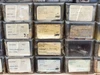 Close-up of bin labels showing Bell & Howell part numbers — screw nut, roller, sprocket assembly, pressure plate visible