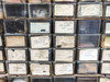 Close-up of individual bin labels showing part numbers including 552-901-12 Wheel Block Fairchild, 737-423 Wiring Assembly Fairchild, 301-796 Clutch Norton, and others