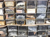 Bins containing visible small hardware parts including gears, screws, stampings, rollers, springs, and mechanical assemblies