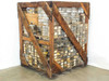 Opposite side of wooden crate showing full height of stacked parts bins secured with wire mesh