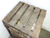 Top view of the wooden pallet crate showing slatted wood lid construction with metal strap reinforcement and partial view of parts bins visible beneath