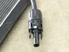 Close-up of MC4 male connector on Solopower SP1 solar panel output lead showing black plastic housing and pin contact