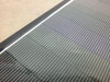 Close-up of the Solopower SP1 CIGS thin-film cell surface showing the fine-line cell scribe pattern on the ETFE top sheet and aluminum edge frame