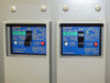 Close-up of two Mitsubishi NV30-CA 3P3E circuit breakers showing 15A and 10A ratings, AC 100-200V 50-60Hz, with ON indicators