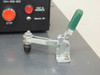 Close-up of QA4-850-000 front panel STOP button and TEST IN PROGRESS / Vibrator ON indicators with Carr-Lane clamp