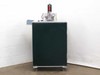 Custom blind rivet station rear-left corner view showing green enclosed cabinet body, aluminum extrusion frame base, and pneumatic upper assembly on top
