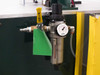 SMC AW30-N03-8Z filter/regulator unit mounted on exterior cabinet panel with pressure gauge, yellow lockout tag, and quick-connect air inlet fitting