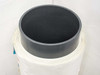 Top view of ultra-thin glass roll showing large black cylindrical core hub and layered glass sheets wound beneath