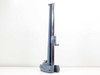 Precision microscope stand left-side profile view showing chrome vertical rail and blue cast column with sliding carriage