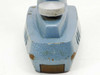 Top-down view of microscope stand base showing fine-adjustment knob and paint chipping with rust on cast metal base