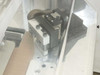 Close-up of right corner trimmer blade assembly – THK HSR20 linear guide with slanted blade and aluminum mounting plate