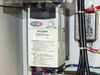 Mitsubishi FR-E520-0.4K Freqrol E500 variable frequency drive installed in USHIO B0048 cabinet, labeled FR-E520-0.4K, with RUN and STOP/RESET controls visible