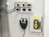 USHIO B0048 cabinet door interior – three overload relays mounted to door, dual-pole disconnect handle, and wiring visible alongside an open component housing