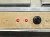Tronic MK IV front control panel close-up showing Refrigeration On and Heater On indicator lights and speed dial knob