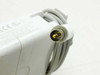 Close-up of Apple A1021 barrel connector tip showing gold-pin circular DIN-style DC output plug