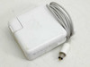 Apple A1021 65W AC power adapter top view showing Apple logo, gray barrel connector cable, and CE/UL certification marks