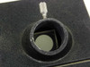 Close-up of swivel photo/camera port on top of microscope head block showing internal beamsplitter prism and knurled locking screw