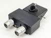 Binocular microscope head block with two adjustable eyepiece tubes and swivel photo port — front-left angled view