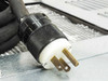 Elkay ER10-1B power cord close-up showing NEMA L5-15P twist-lock plug and condenser grille in background