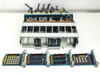 Overhead view of chassis with cards removed showing backplane, and four 24-channel I/O cards laid out below — card PCBs visible