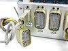 Close-up of rear connector panel showing J99, JH4, and JG4 multi-pin military-style connectors with mating cable plug in foreground