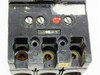 Unbranded 3-pole MCCB — top line-side view showing three Lo/Hi trip adjustment screws and red reset button