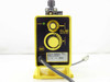 LMI Milton Roy P121-358SI dosing pump — front panel view showing stroke indicator LED, adjustment dials, NSF certification mark, and rating label