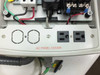 AC panel cover of enclosure showing two standard AC outlets and knockout holes