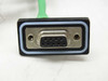 Close-up of DB-9 female connector on external green cable exiting the enclosure