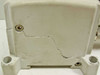 SMC EX250-SDN1 cracked plastic housing — close-up showing significant crack running across the bottom/side enclosure panel