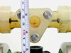 Marathon MP02P-73 top manifold and fluid port area closeup with tape measure showing port spacing; visible staining/discoloration on manifold