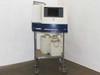 Origen IGEN M-Series M8 Toxin Analyzer full unit on rolling wire cart with two reagent containers on lower shelf – front-left view