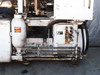 Sumitomo SD30 – lower right base showing hydraulic manifold with surface rust and accumulator tank