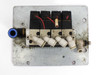 SMC VK332-5G-01 solenoid valve manifold – bottom view showing four valve outlets with push-in fittings and metal mounting plate