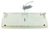 Apple M2980 keyboard bottom view showing underside with label, rubber feet, fold-out feet in raised position, and dirt/debris accumulation along spine